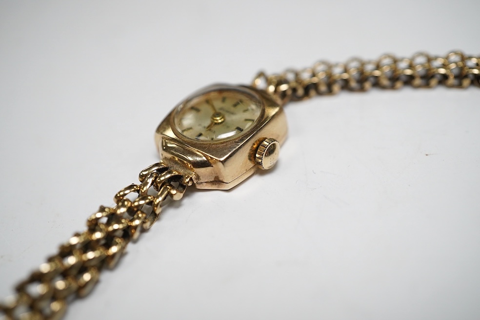 A lady's 9ct gold Accurist manual wind wrist watch, on a 9ct gold bracelet, gross weight 12.3 grams. Condition - fair